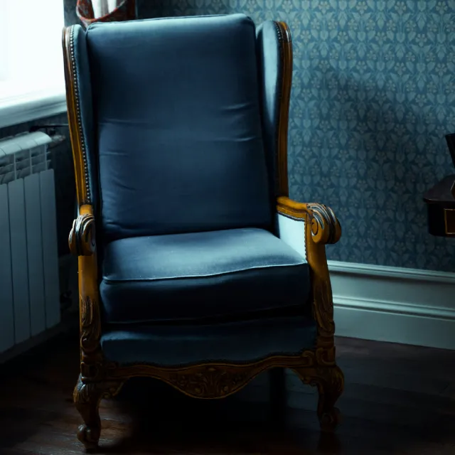 Comfy blue upholstered antique chair